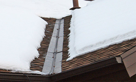 A roof de-icing system installed along roof edges and valley.